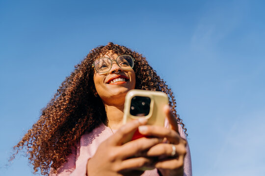 A woman using a mobile phone standing outdoors