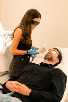 Man receives a non-invasive facial procedure.