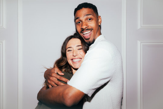 Happy couple embracing with joyful expressions