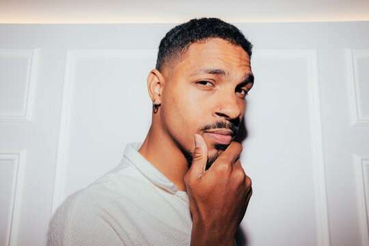 Thoughtful man posing against white wall background