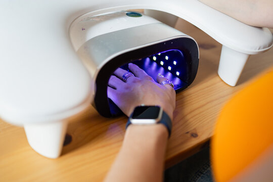 Close-up of a gel manicure under UV light
