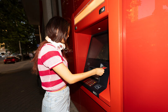 Inserting credit card in street ATM