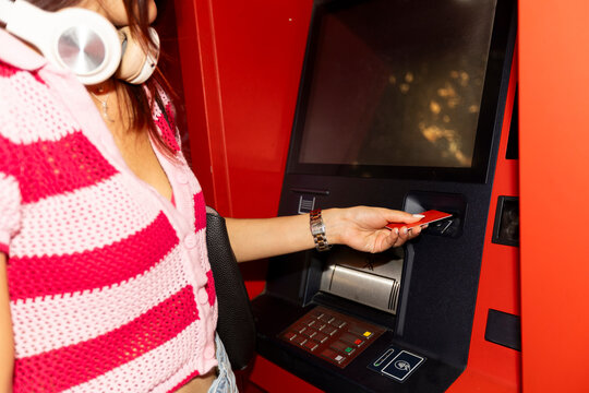 Inserting credit card in street ATM