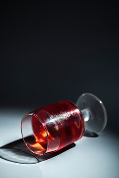 Spilled Red Drink on a Flat Surface With Dark Shadows