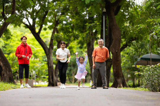 Family exercising and jogging together in city park summer. healthy lifestyle in nature. Father mother, kids daughter exercise. Family team, healthy children. healthy lifestyle and family bonding
