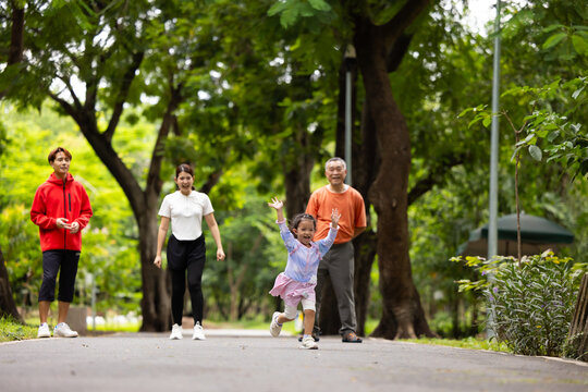 Family exercising and jogging together in city park summer. healthy lifestyle in nature. Father mother, kids daughter exercise. Family team, healthy children. healthy lifestyle and family bonding