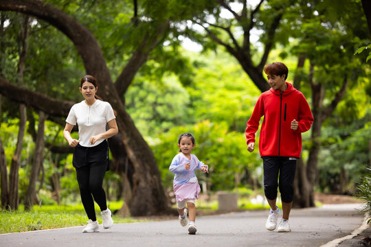 Family exercising and jogging together in city park summer. healthy lifestyle in nature. Father mother, kids daughter exercise. Family team, healthy children. healthy lifestyle and family bonding