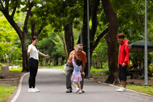 Family exercising and walking together in city park summer. healthy lifestyle in nature. Father mother, kids daughter exercise. Family team, children. healthy lifestyle and family bonding