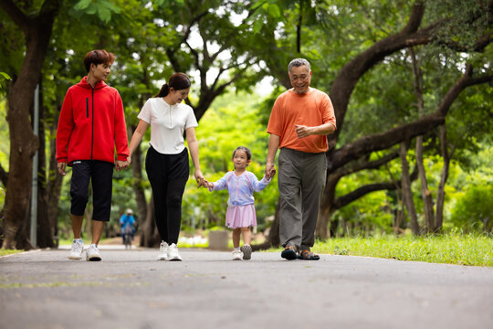 Family exercising and walking together in city park summer. healthy lifestyle in nature. Father mother, kids daughter exercise. Family team, children. healthy lifestyle and family bonding