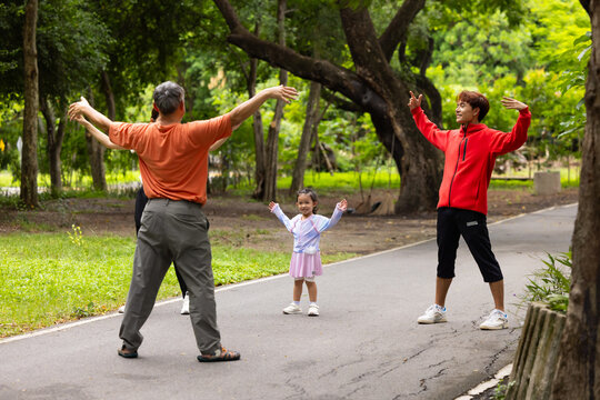 family stretching in city park summer. healthy lifestyle in nature. Father mother, kids daughter exercise together. Family team, healthy children. healthy lifestyle and family bonding