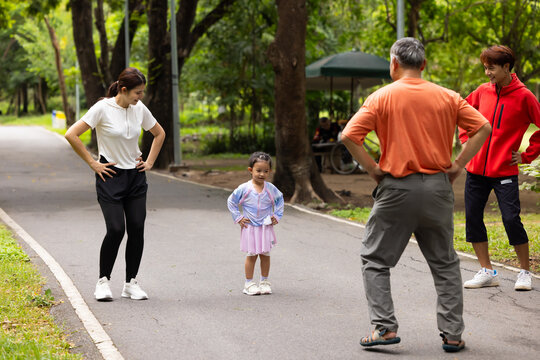 family stretching in city park summer. healthy lifestyle in nature. Father mother, kids daughter exercise together. Family team, healthy children. healthy lifestyle and family bonding