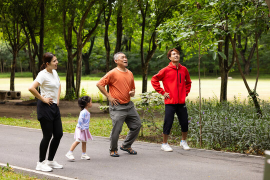 family stretching in city park summer. healthy lifestyle in nature. Father mother, kids daughter exercise together. Family team, healthy children. healthy lifestyle and family bonding