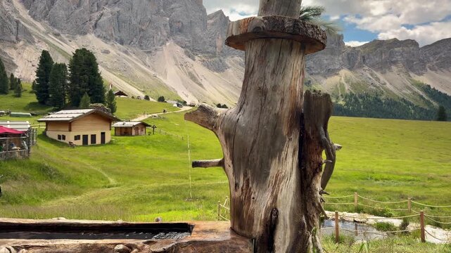 Rustic Wooden Fountain With Alpine Huts And Dolomites Scree Slope Mountain South Tyrol Italy Rifugio Meadow Summer 4K
