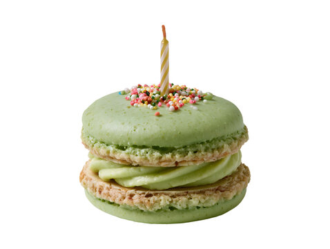 Green pistachio macaron with birthday candle and sprinkles isolated on transparent or white background, png
