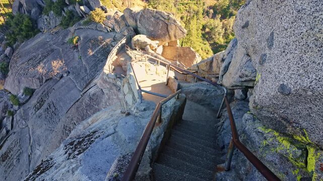 Golden sunrise light glows over the winding stairs to Moro Rock in Sequoia National Park
