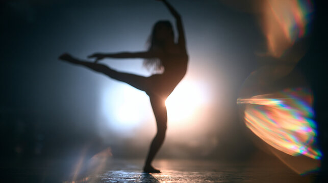 Female Dancer in Silhouette Performing with Dramatic Lighting