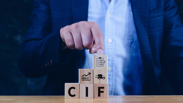 CIF Cost Insurance Freight incoterms concept. businessman touching letter on wooden cube for global trade shipping and logistics business. not ai