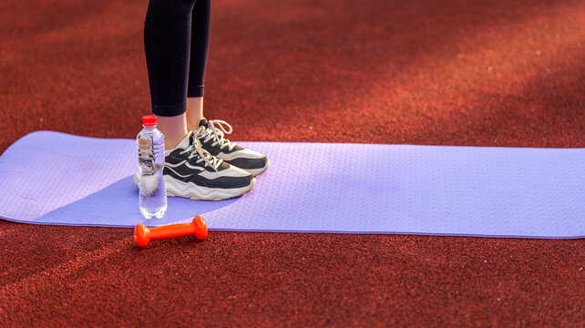 Fitness equipment laid out on a track for an outdoor workout session