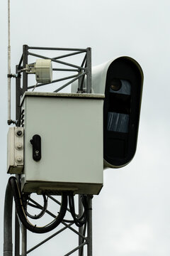 Fixed speed camera mounted on a roadside metal tower