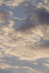 Obraz premium Dramatic dark storm clouds catching golden warm sunlight during sunset