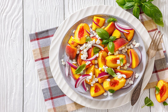 Fresh peach salad with goat cheese on a plate