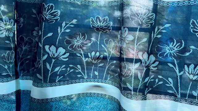 Blue Floral Pattern Curtain Hanging by Window in Soft Sunlight