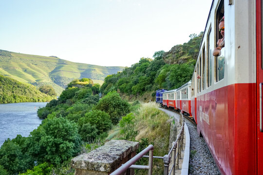 Scenic view from a passenger window of a regional train traveling along the iconic Douro Line in Portugal