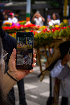 Traditional silleteros carrying flower arrangements during a cultural festival parade
