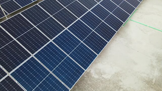 Close Aerial Drone Flyover of Solar Panel Array on Commercial Rooftop for Clean Energy. Industrial Solar