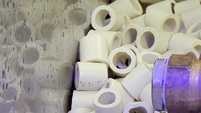Observe the intricate workings of an advanced hydro air purification system. Ceramic rings actively cleanse the atmosphere, capturing impurities in a misty, liquid environment.