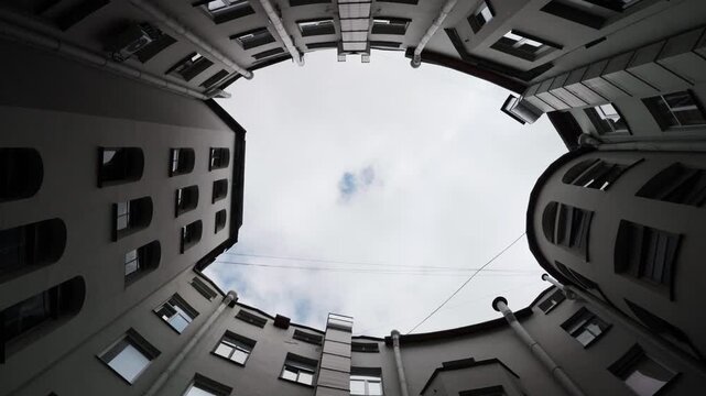 Building courtyard worm's eye view with overcast sky