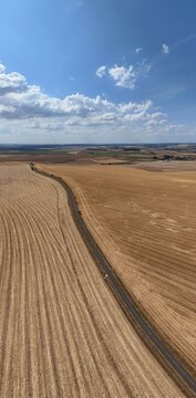 vue a&eacute;rienne panoramique des champs apr&egrave;s la moisson. Paysage rural et agricole en Meurthe-et-Moselle, Lorraine. Ciel bleu avec des gros nuages cumulus en &eacute;t&eacute;. France 2026