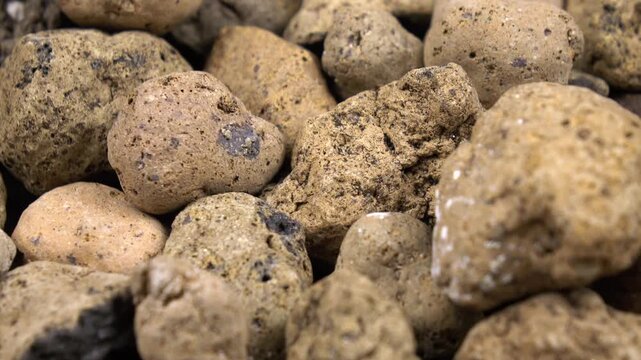 Clay balls as a drainage. Drainage materials for a potted houseplant, top view, background