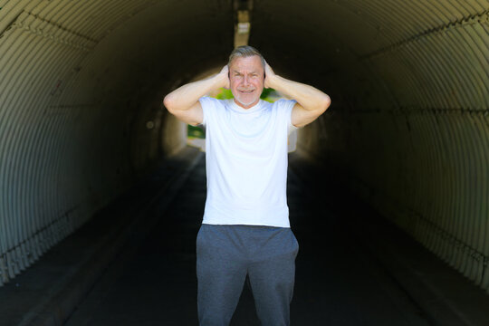 Stressed Mature Man Covering Ears