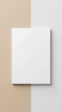 Top-down view of a blank portrait magazine mockup with a white cover centered on a split beige and gray background.