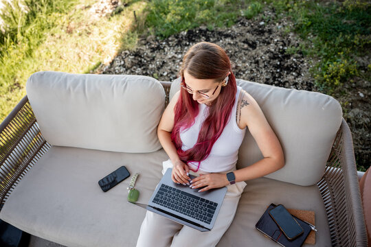Young freelancer working outdoors on laptop