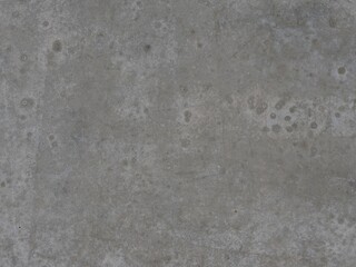 Obraz premium A flat top-down full-frame photograph of a weathered gray concrete floor texture with subtle dark spots and fine surface imperfections.