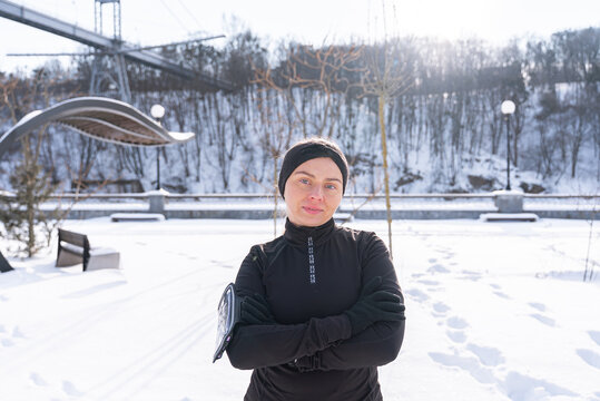 Woman in winter workout clothing at snowy outdoor park