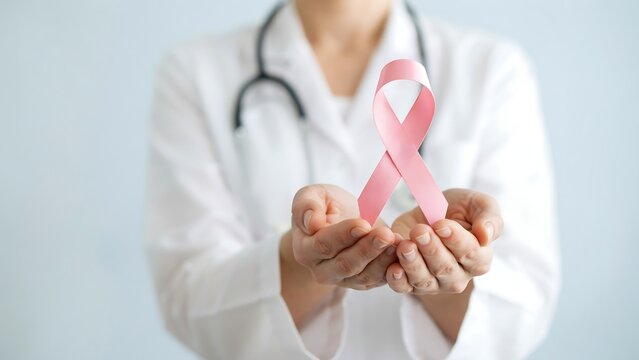 Doctor holding pink breast cancer ribbon. Medical professional supporting awareness campaign.