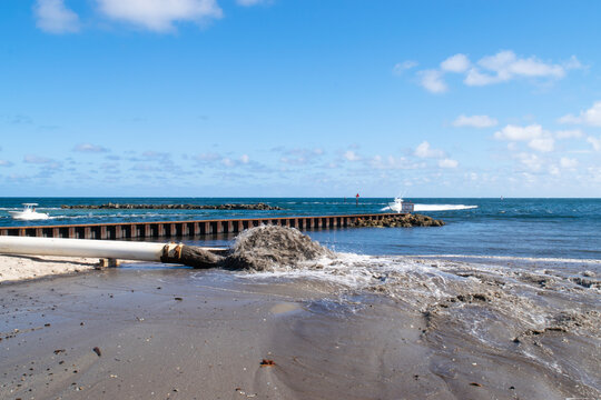 Waste water discharge pipe into canal and sea Pompano Beach FL, USA clear sunny day