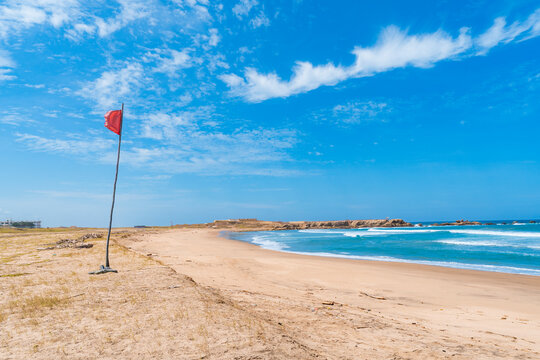 La Chocolatera beach with red flag in Ecuador