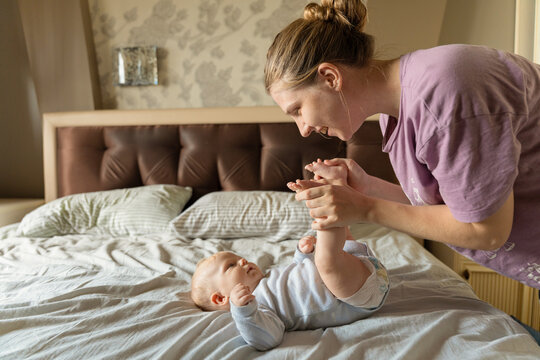 Mother bonding with baby during playtime at home
