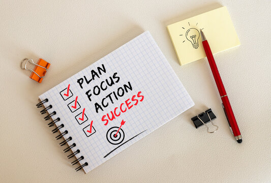 Plan Focus Action Success Checklist on Notebook in Organized Workspace.