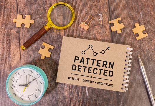 Pattern Detected Concept on Notebook with Magnifying Glass, Puzzle Pieces