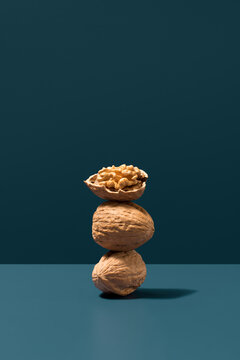 Walnuts stacked on blue background in artistic display