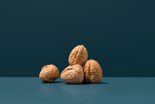 Walnuts with shells on blue background