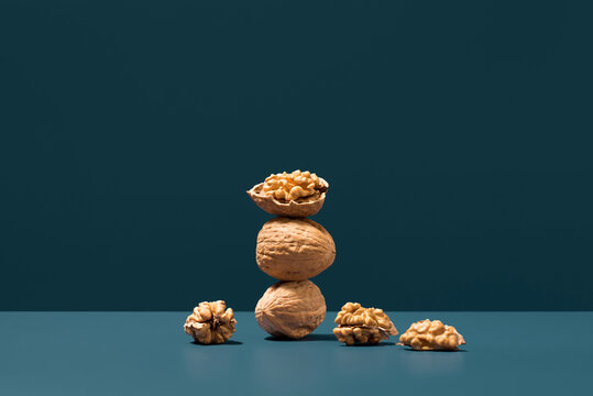 Walnuts stacked on blue backdrop