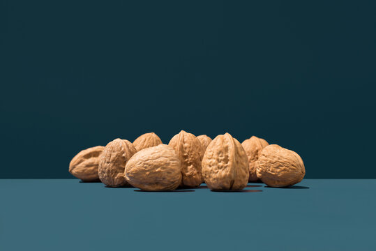 Whole walnuts in shell on blue background