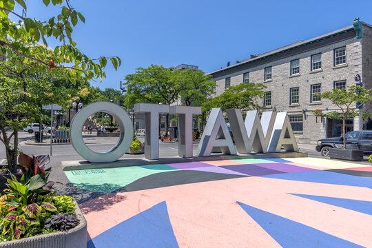 Ottawa, ON, Canada. Aug 1, 2026. Eye level view of large Ottawa sign letters on colorful painted plaza in Byward Market on sunny day.