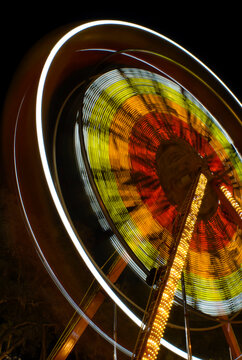 Lighted ferris wheel creating abstract patterns